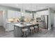 Modern kitchen featuring an island with seating, pendant lighting, and stainless steel appliances at 137 Cultivator Ct, Angier, NC 27501