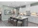 Bright eat-in kitchen with island, modern lighting, stainless sink, quartz countertops, and seating for four at 137 Cultivator Ct, Angier, NC 27501
