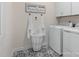 Laundry room featuring updated washer and dryer, decorative floor tiles and storage at 137 Cultivator Ct, Angier, NC 27501