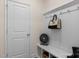 Mudroom with built-in bench, cubbies, hooks, and white wainscotting at 137 Cultivator Ct, Angier, NC 27501