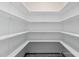 Walk-in pantry featuring bright lighting and white shelving from floor to ceiling at 137 Cultivator Ct, Angier, NC 27501