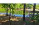 Scenic backyard view showcasing waterfront access, a private dock, and a covered boat slip at 1605 Sagamore Dr, Louisburg, NC 27549