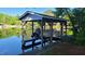 Covered boat slip with boat ready for your enjoyment on the lake at 1605 Sagamore Dr, Louisburg, NC 27549