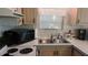 This kitchen features a microwave, range, and double sink with wood cabinets at 1605 Sagamore Dr, Louisburg, NC 27549