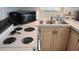 This kitchen includes a microwave, range, and double sink with wood cabinets at 1605 Sagamore Dr, Louisburg, NC 27549