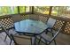 This is a screened porch with a glass-topped table and seating for six at 1605 Sagamore Dr, Louisburg, NC 27549