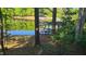 This is a waterfront scene with a covered boat dock and trees at 1605 Sagamore Dr, Louisburg, NC 27549