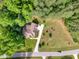 Aerial view of a home with lush surrounding trees and a long driveway at 1619 Carriage Dr, Franklinton, NC 27525