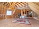 Spacious unfinished attic ready for customization, featuring wood framing and natural light at 1619 Carriage Dr, Franklinton, NC 27525