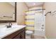 Well-lit bathroom with a dark vanity, modern fixtures, and a shower-tub combination at 1619 Carriage Dr, Franklinton, NC 27525