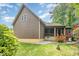 Exterior view of a home showcasing the back, with a screened porch and well-maintained yard at 1619 Carriage Dr, Franklinton, NC 27525