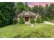 Charming home with a manicured lawn, lush landscaping, and stone accents at 1619 Carriage Dr, Franklinton, NC 27525
