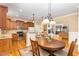 Spacious eat-in kitchen featuring an island with bar seating, hardwood floors, and stainless appliances at 1619 Carriage Dr, Franklinton, NC 27525