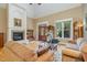 Cozy living room with fireplace, high ceiling, hardwood floors, and ample seating at 1619 Carriage Dr, Franklinton, NC 27525