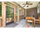 Relaxing screened-in patio with ceiling fan, a table and chairs, and outdoor views at 1619 Carriage Dr, Franklinton, NC 27525