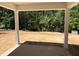 Inviting covered patio space with views of the tranquil wooded backyard at 169 Pecan Valley Way, Four Oaks, NC 27524