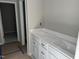 Bathroom with a long white vanity, cabinets, and white countertops at 169 Pecan Valley Way, Four Oaks, NC 27524