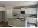 Bright kitchen featuring an island, stainless appliances, and lots of natural light at 169 Pecan Valley Way, Four Oaks, NC 27524