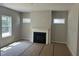 Cozy living room featuring a fireplace and multiple windows at 169 Pecan Valley Way, Four Oaks, NC 27524