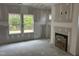 Spacious living room with a fireplace and large windows ready for your customization at 169 Pecan Valley Way, Four Oaks, NC 27524