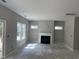 Spacious living room with neutral walls and a fireplace at 169 Pecan Valley Way, Four Oaks, NC 27524