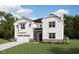 New construction two-story home with white siding, black roof, manicured lawn, and attached two-car garage at 179 Yellow River Way, Garner, NC 27529