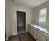 Bathroom with a long vanity featuring white cabinets and a large window at 183 Pecan Valley Way, Four Oaks, NC 27524