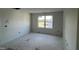 Bright, unfinished bedroom featuring a window with a view of the outdoors at 183 Pecan Valley Way, Four Oaks, NC 27524