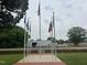 Array of flagpoles display flags in a manicured park-like setting at 183 Pecan Valley Way, Four Oaks, NC 27524