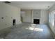 Spacious living room featuring a fireplace and large windows that let in natural light at 183 Pecan Valley Way, Four Oaks, NC 27524