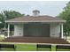 The Oak Pavilion features a stage, ceiling fans, and a grassy surround with benches for outdoor enjoyment at 183 Pecan Valley Way, Four Oaks, NC 27524