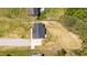 Aerial view of house with spacious yard, driveway, and surrounding greenery at 1914 Jack Rd, Clayton, NC 27520