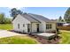 Exterior view with back porch, two back doors, green grass and manicured landscaping at 1914 Jack Rd, Clayton, NC 27520