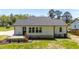 Rear exterior with a concrete back porch, back door, and green grass at 1914 Jack Rd, Clayton, NC 27520