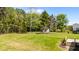 View of lush green backyard with bordering woodland trees at 1914 Jack Rd, Clayton, NC 27520