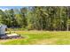 Expansive backyard with a well-manicured lawn and natural woodland border at 1914 Jack Rd, Clayton, NC 27520