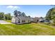 View of a grassy backyard with a neighboring pool and houses at 1914 Jack Rd, Clayton, NC 27520