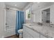Well-lit bathroom with a shower/tub combo and a granite countertop vanity at 1914 Jack Rd, Clayton, NC 27520