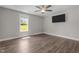 Bright bedroom with a large window providing great natural light and wood flooring at 1914 Jack Rd, Clayton, NC 27520