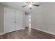 Bright bedroom featuring wood-look flooring, a ceiling fan, and a closet with paneled doors at 1914 Jack Rd, Clayton, NC 27520