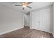 Bright bedroom featuring wood-look flooring, a ceiling fan, and a closet with paneled doors at 1914 Jack Rd, Clayton, NC 27520