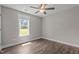 Cozy bedroom featuring wood floors and a window letting in natural light, creating a peaceful retreat at 1914 Jack Rd, Clayton, NC 27520