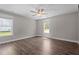 Spacious bedroom featuring wood-look flooring, a ceiling fan, and windows at 1914 Jack Rd, Clayton, NC 27520
