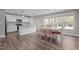 Eat-in kitchen featuring modern appliances, white cabinets, and a dining area with natural light at 1914 Jack Rd, Clayton, NC 27520