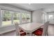 Bright dining room featuring a large window, modern table and chairs, and wood flooring at 1914 Jack Rd, Clayton, NC 27520