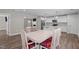 Bright dining room featuring an open layout, wood floors, and views of the modern kitchen and living room at 1914 Jack Rd, Clayton, NC 27520