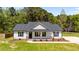 Charming single-story home featuring a landscaped front yard and classic architectural details at 1914 Jack Rd, Clayton, NC 27520