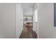 Hallway view into an eat-in kitchen area with white cabinets and a table near the window at 1914 Jack Rd, Clayton, NC 27520