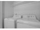 Laundry room showcasing a white washer and dryer set and an overhead shelf for storage at 1914 Jack Rd, Clayton, NC 27520