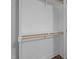 Practical walk-in closet with shelving and wooden rod, providing efficient storage space at 1914 Jack Rd, Clayton, NC 27520